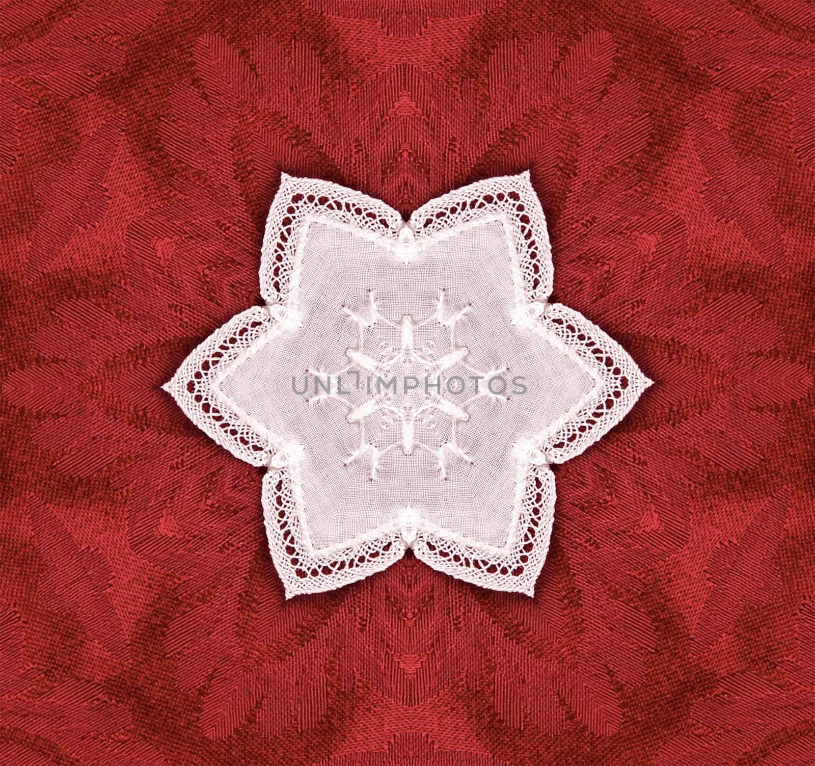 hexagonal lace star on red tapestry background