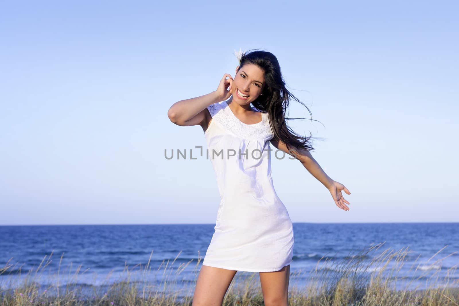 Beautiful brunette posing free with sunset sun on the beach