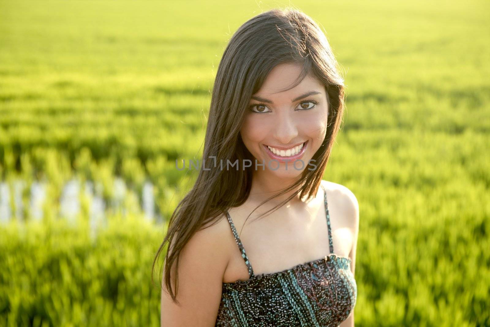 Beautiful brunette indian woman in green rice fields by lunamarina