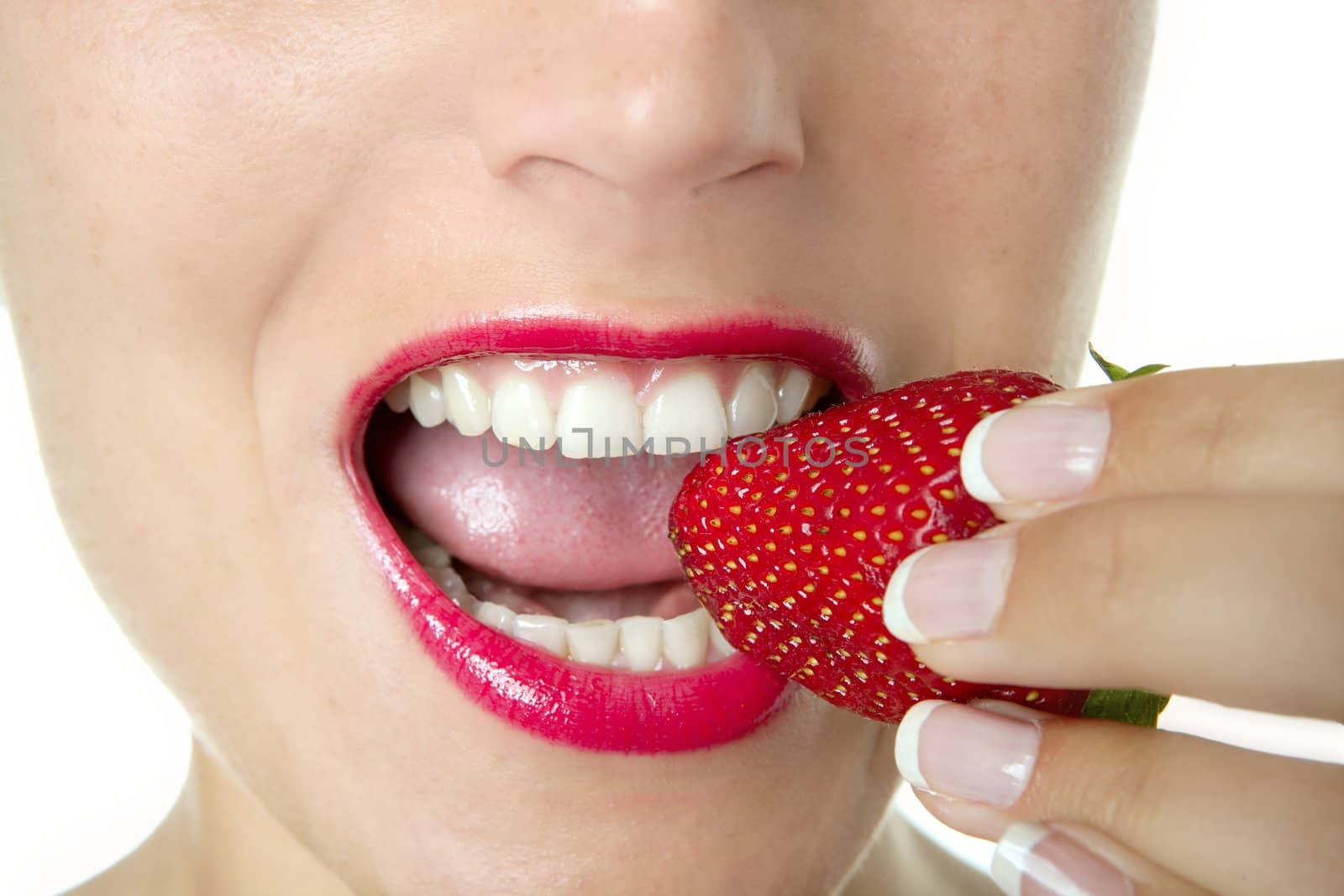Beautiful woman eating a red strawberry by lunamarina
