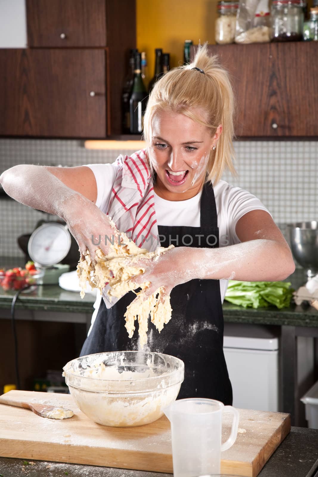 Female chef with her hands covered in sticky dough