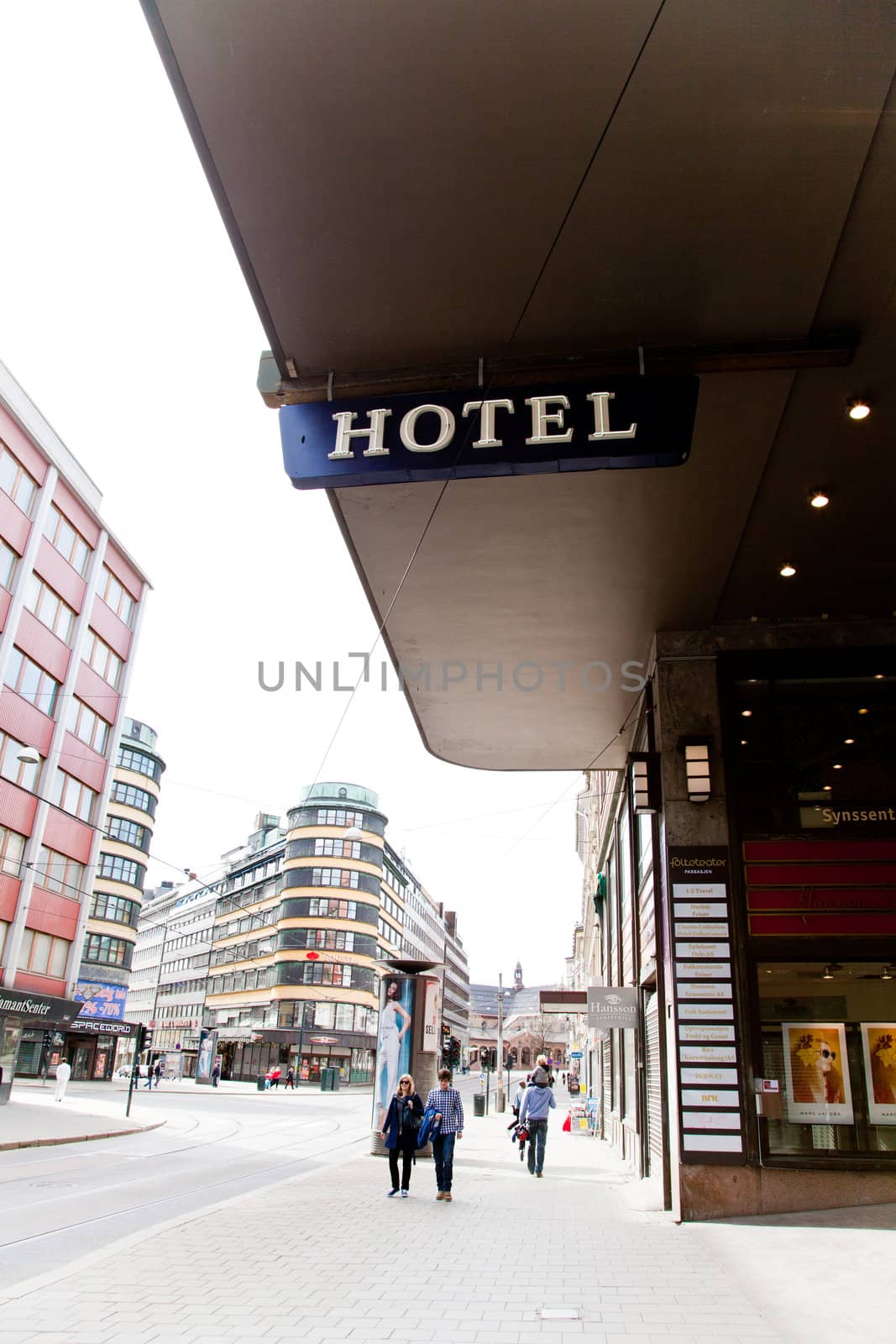 Hotel sign in city. The Background is over exposed to emphasise the hotel sign.