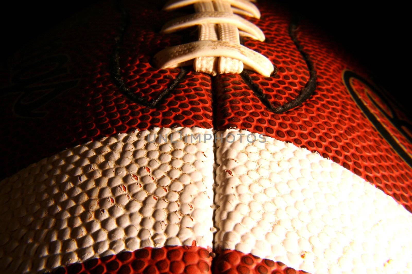 A closeup of an American Football, low key