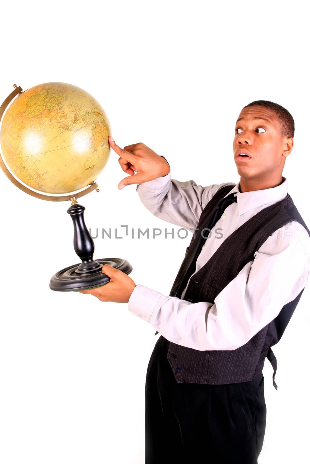 A young man pointing at a globe and looking surprised