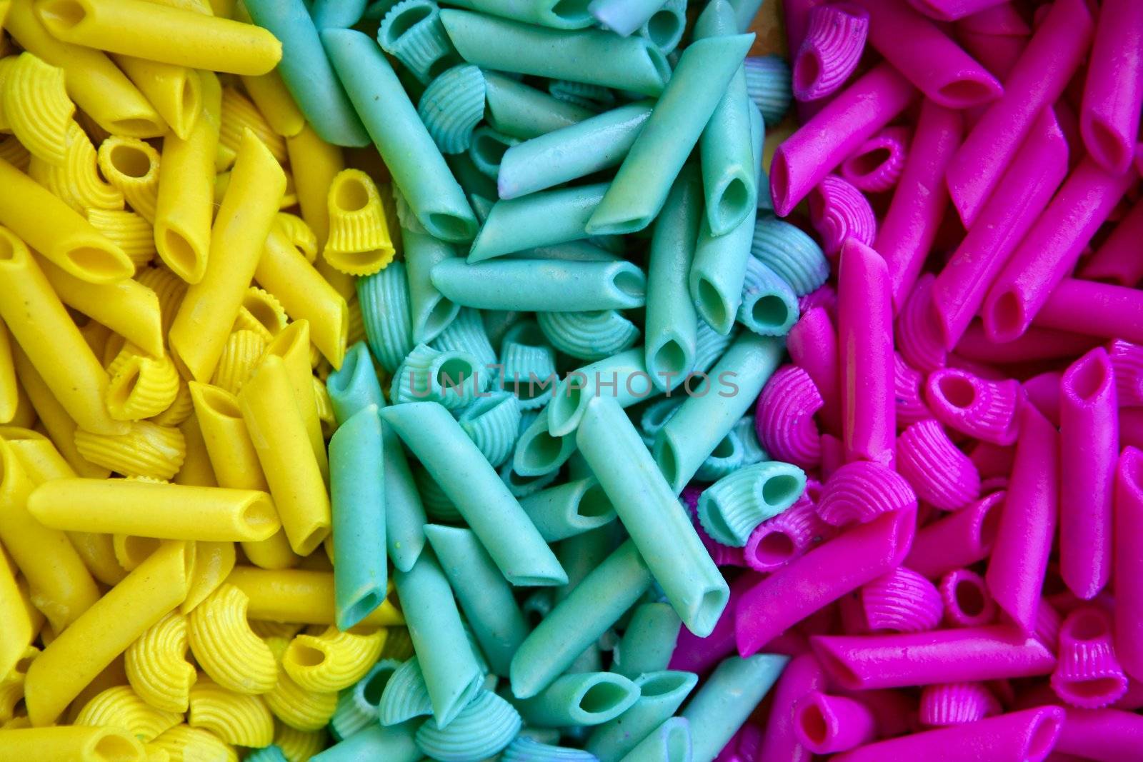 Colorful pasta food in three colors, yellow, blue and pink