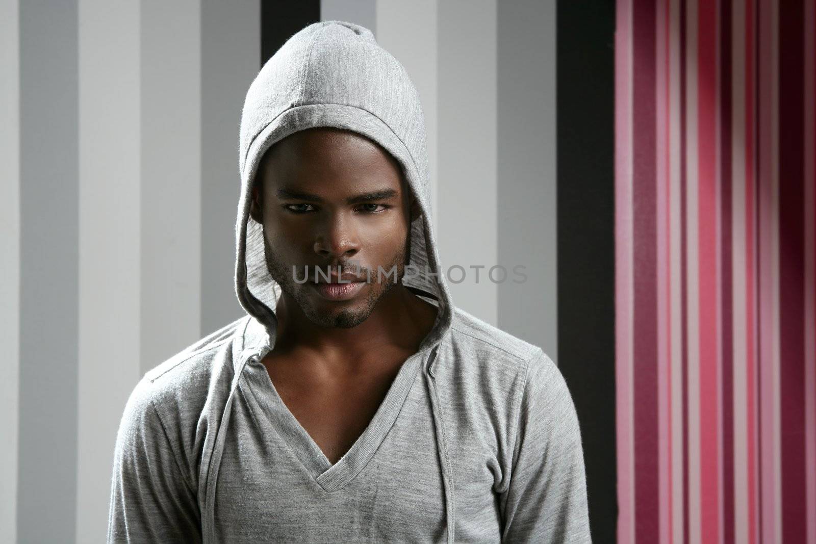 African american man with gray hood over wallpaper background