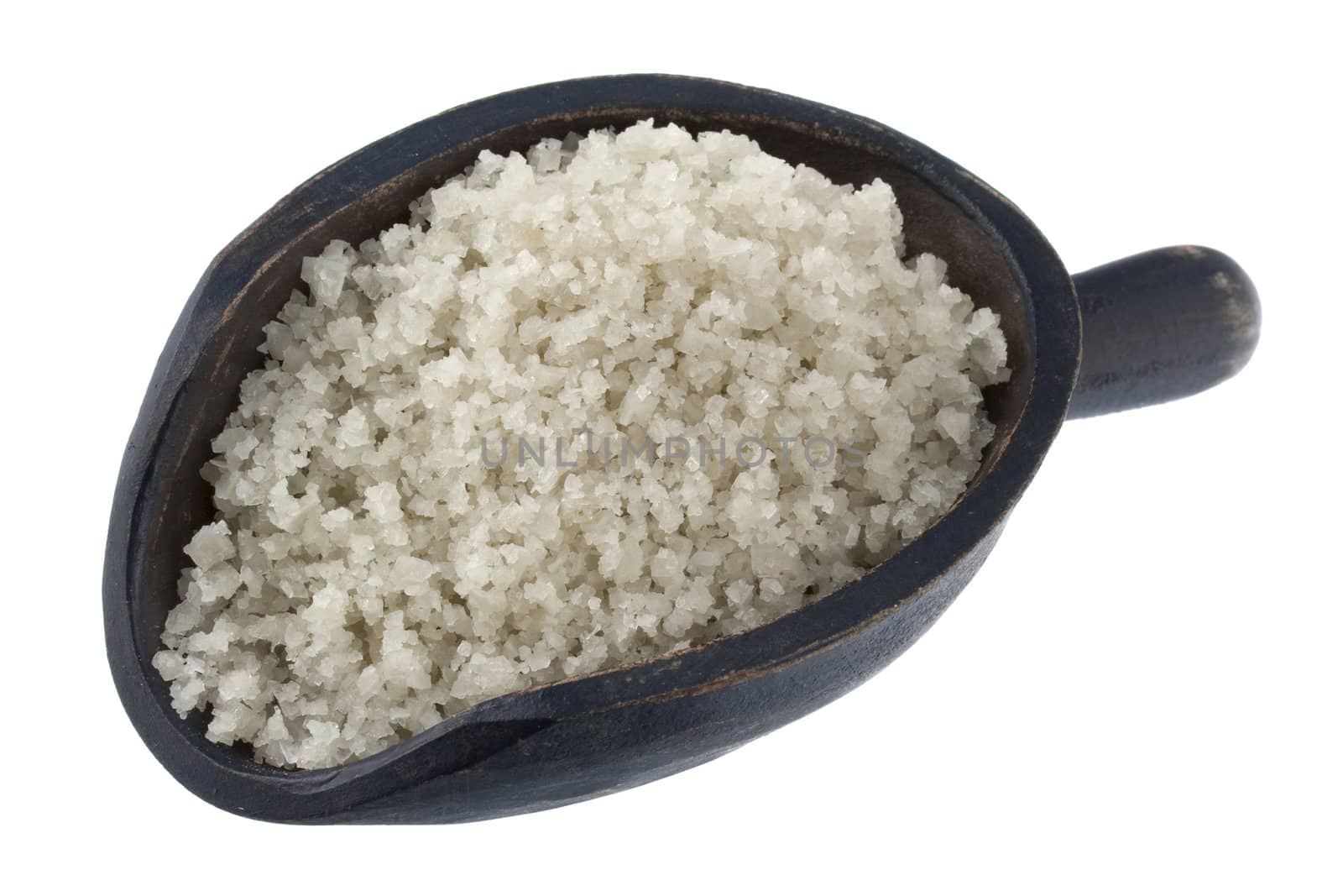 gray sea salt crystals on a rustic wooden scoop, isolated on white