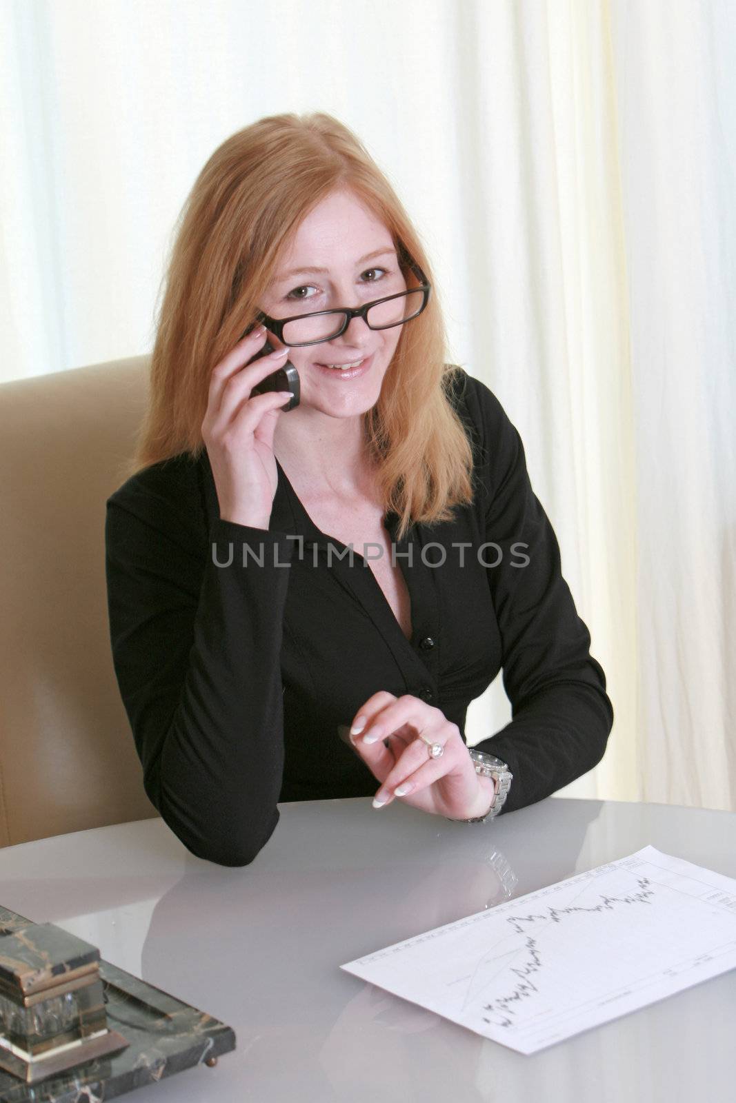 a business woman on the phone and smiling
