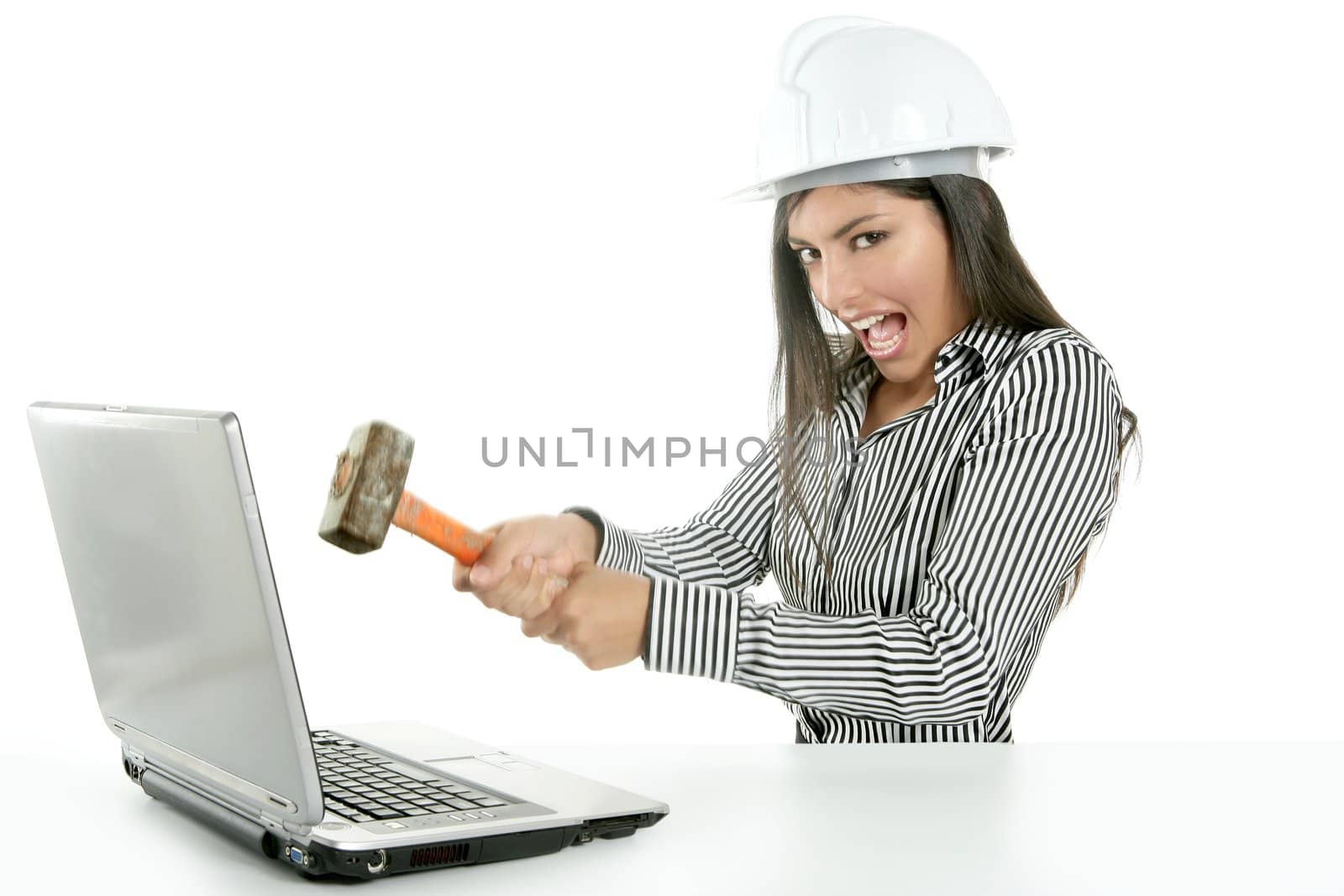 Angry brunette businesswoman with hammer against screen