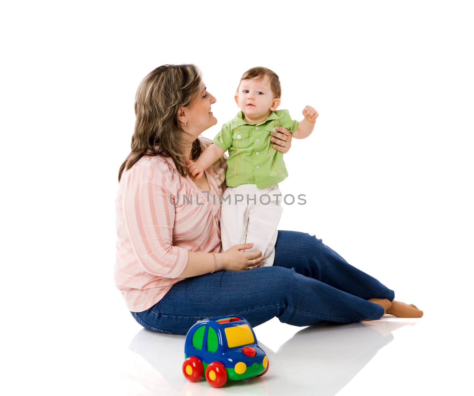 Mother playing with child holding car isolated on white