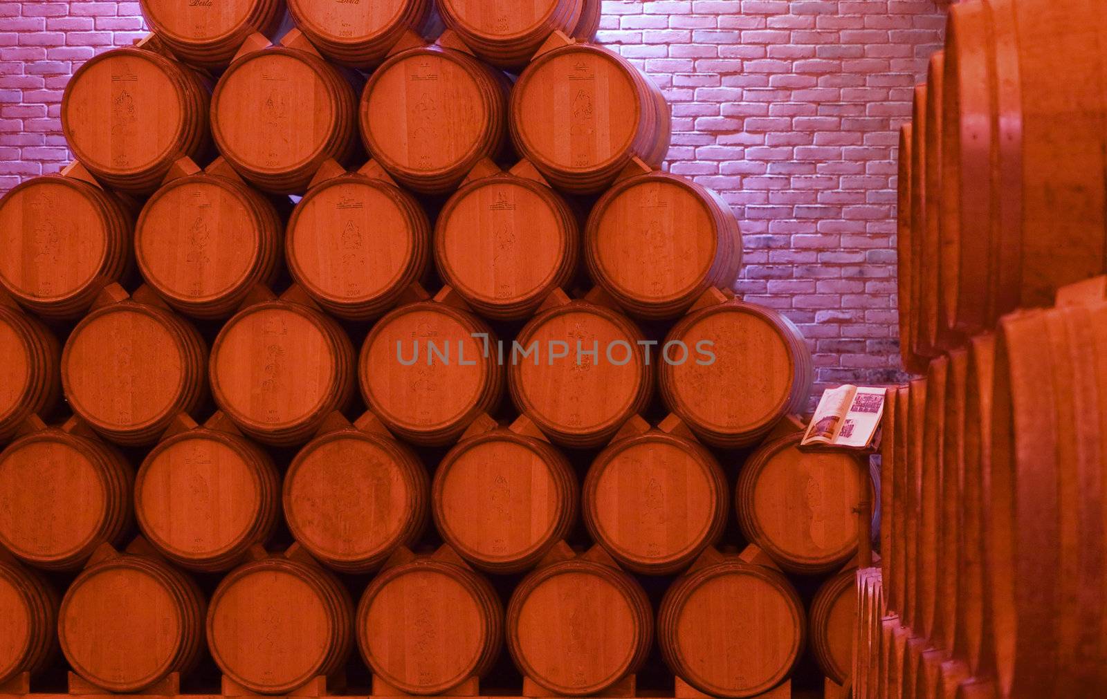 Pile of barrels of wine under red light