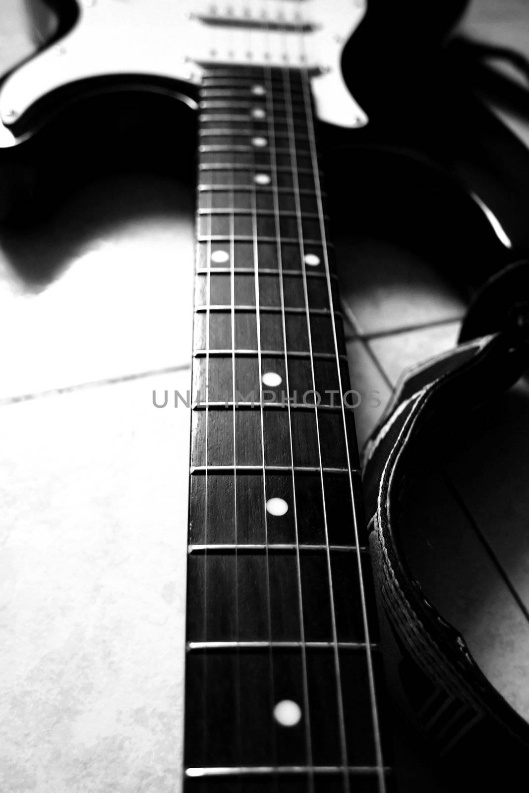Black and white close up of neck of guitar
