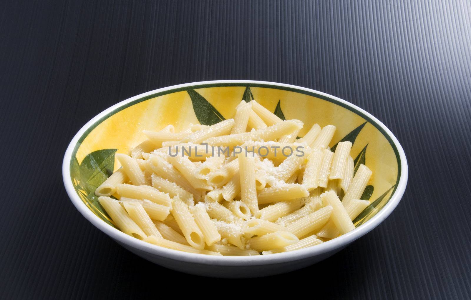 A plate full of italian pasta (maccheroni al burro), over a black background