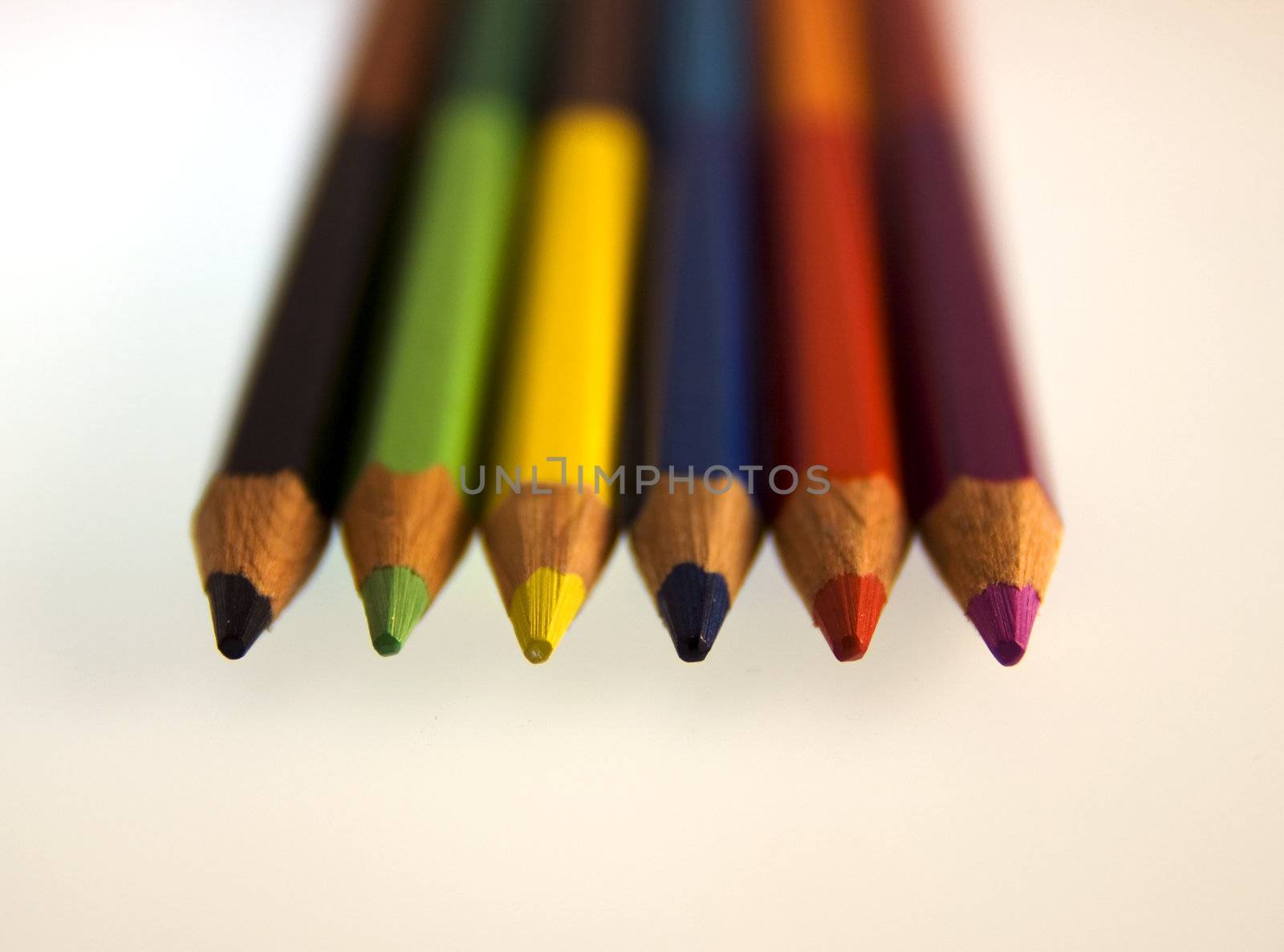 Six coloured pencils on a white background