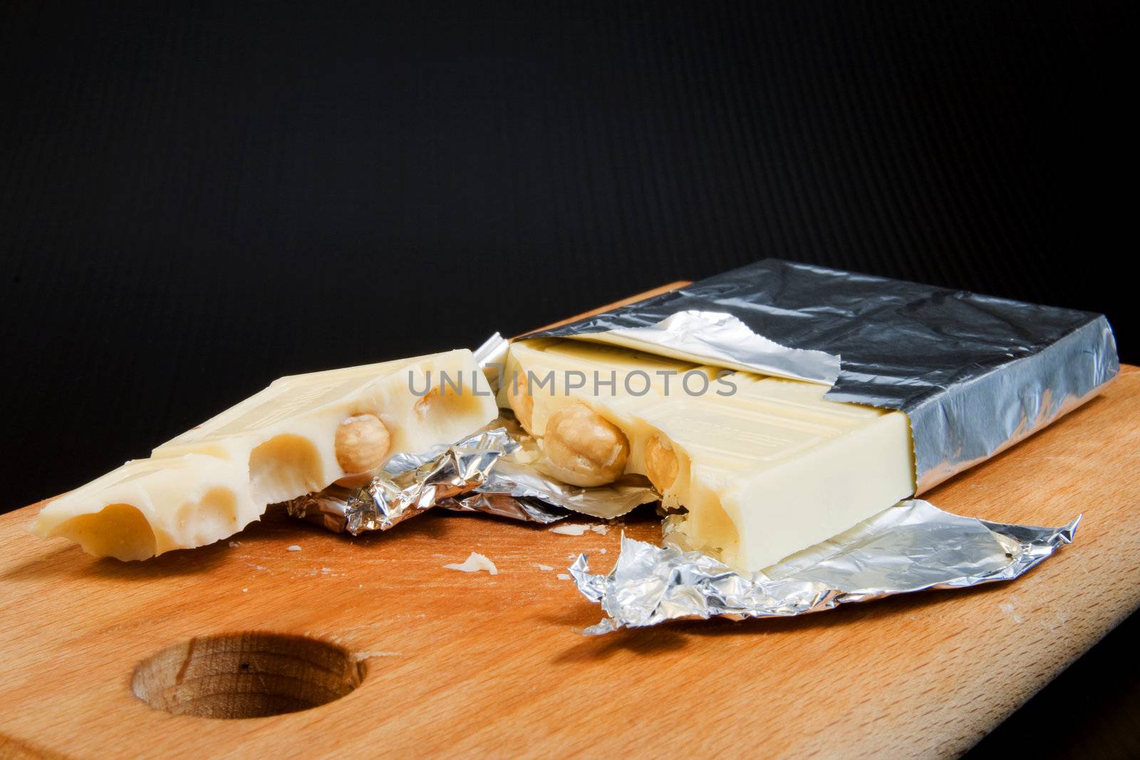 Italian White chocolate with nuts, on wooden cutting board