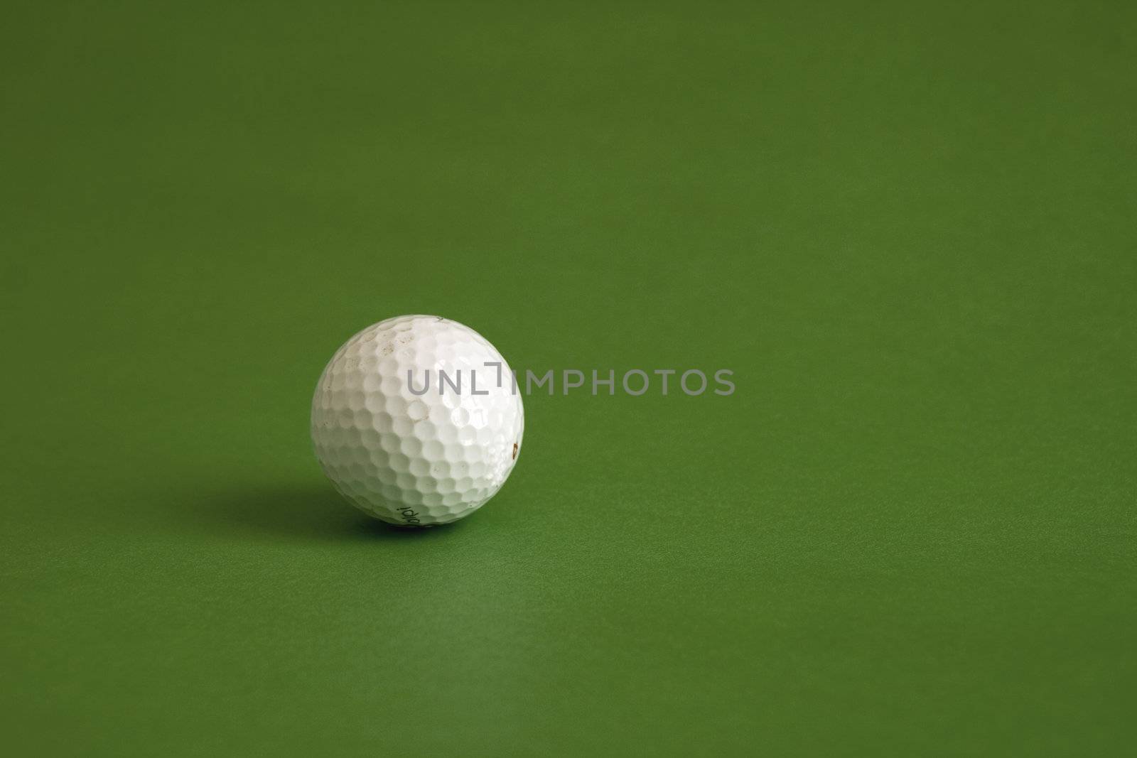 A white golf ball on a big green