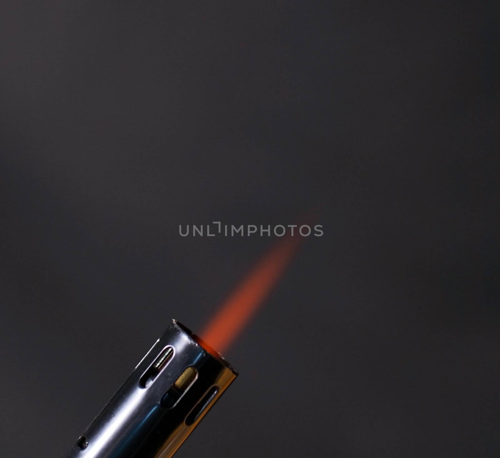 Flame shoting out of a torch with smoke background