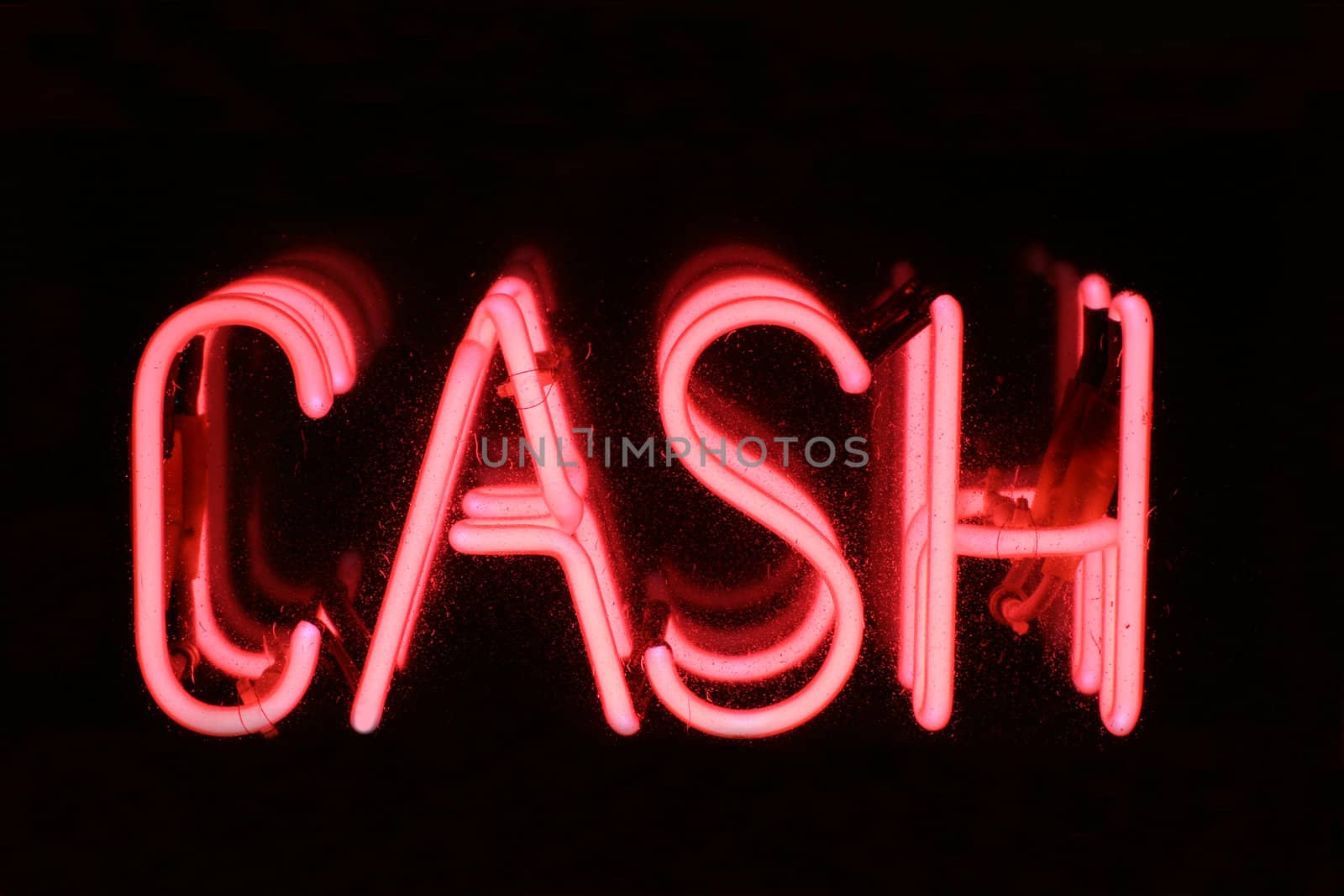 A Pink neon sign spelling out the words CASH. Set on a black background.