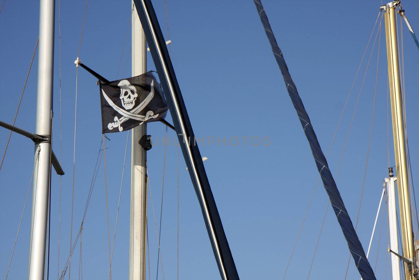 Skull and cross bones flag on a flagpole of a yaht