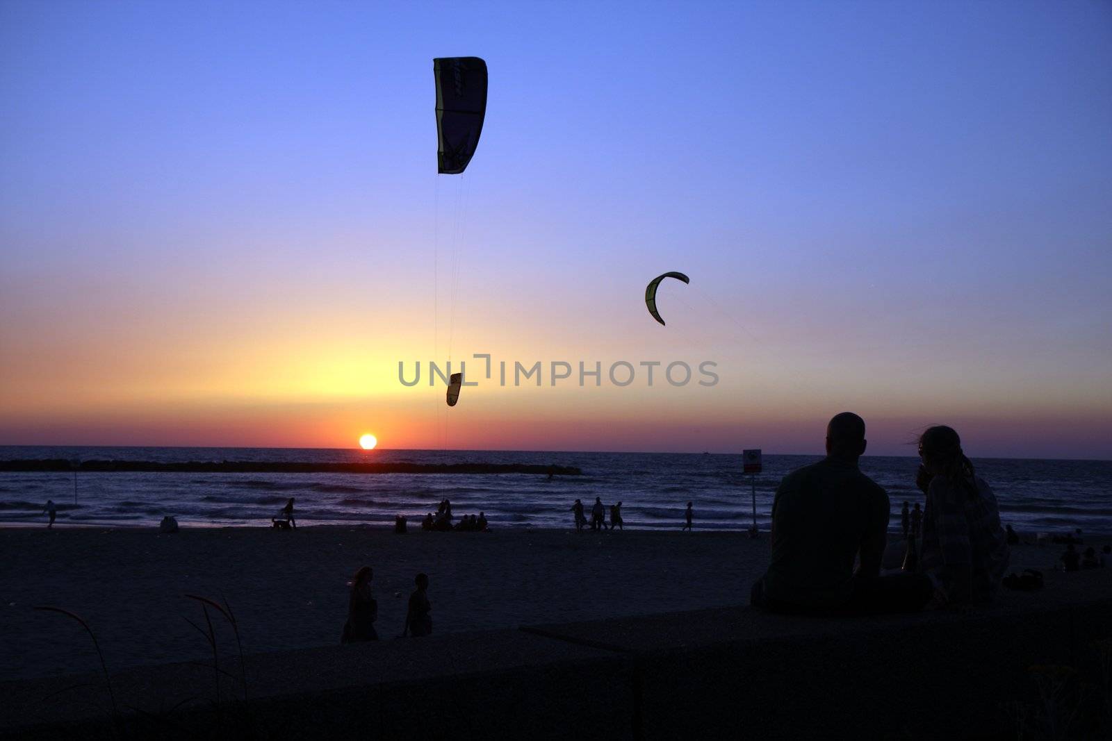 Romantic sunset at Tel Aviv beach with a pait and kites