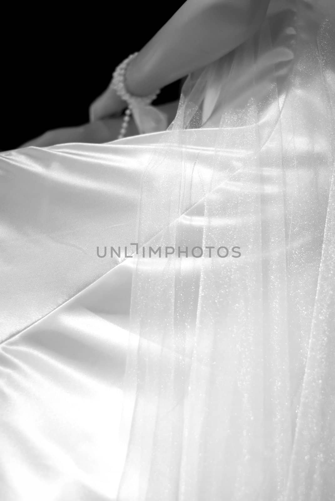 Silky shiny and thin translucent fabrics used in part of a wedding gown dressed on a mannequin