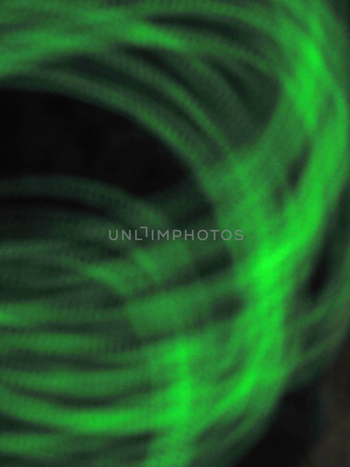 Green Swirl Background abstract representation of green coils on a black background.
