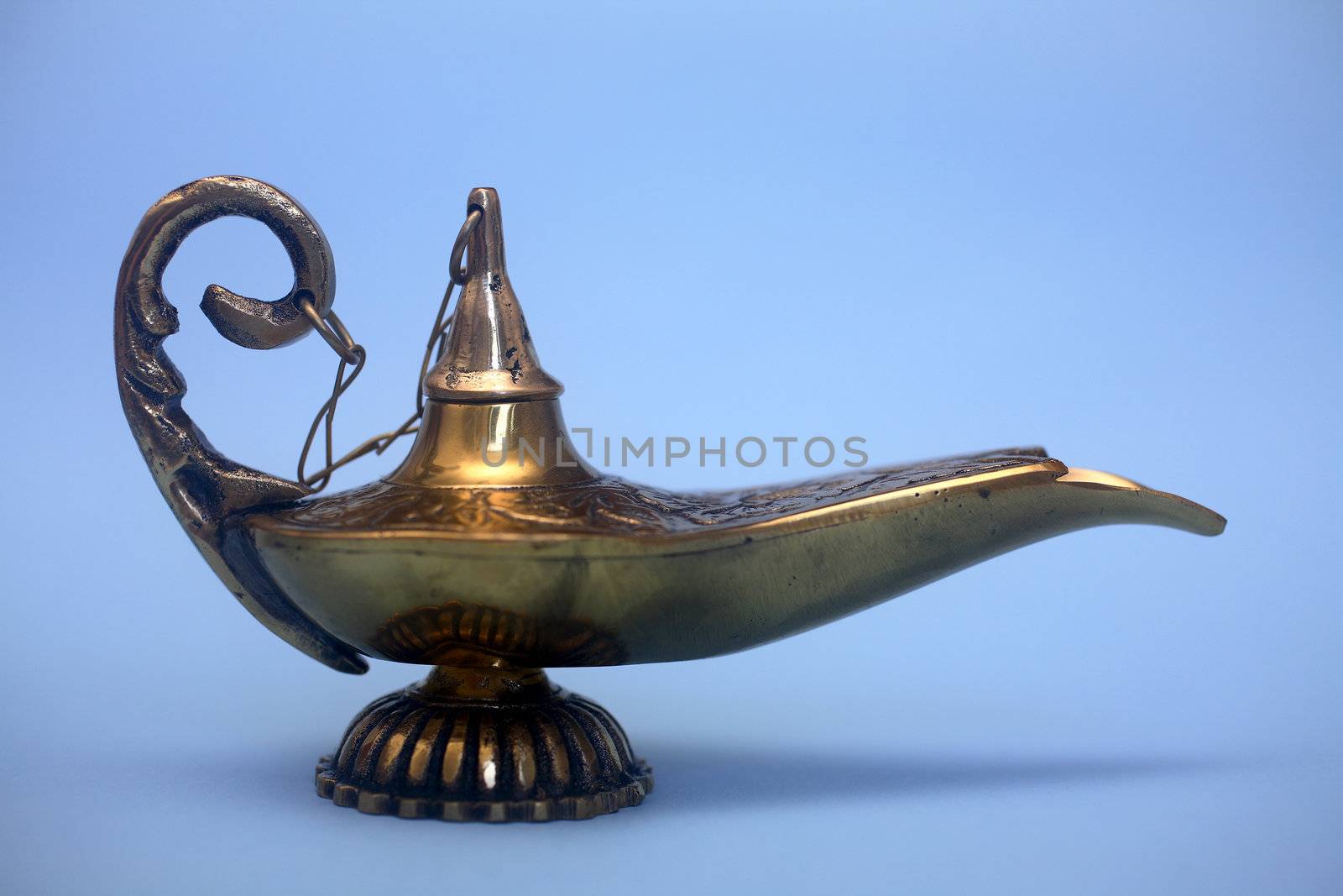 An isolated golden or bronze magic genie lamp, like Aladdins! :)