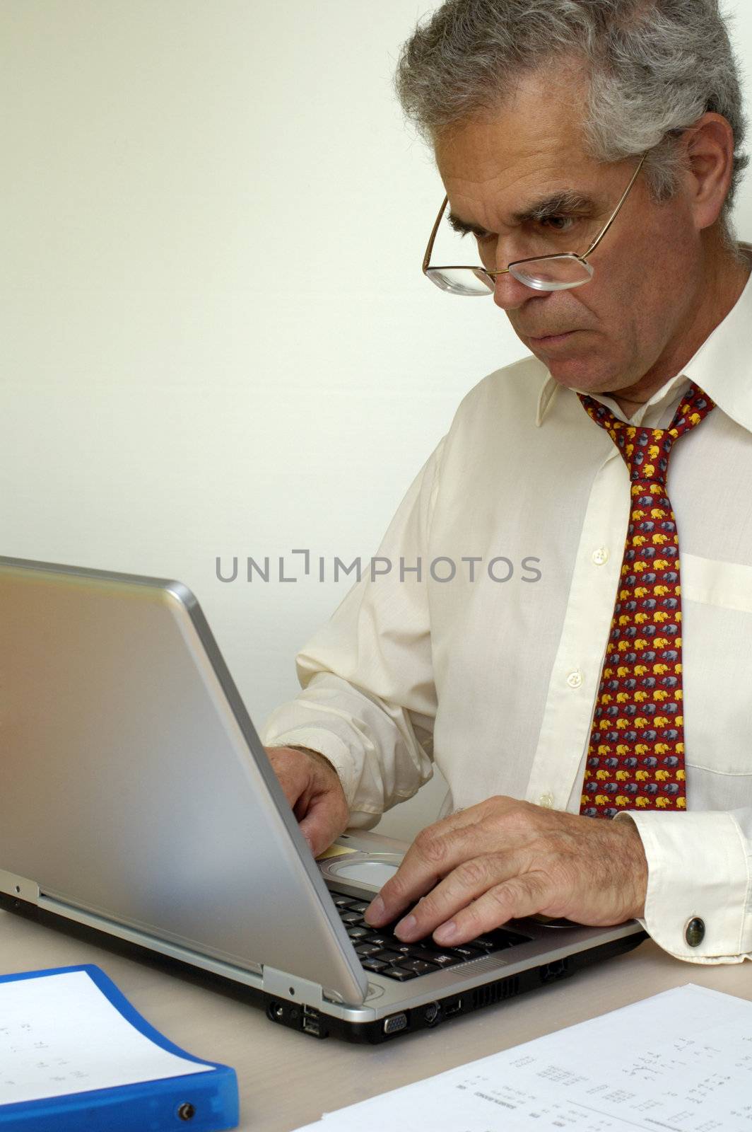 A mature businessman working at his laptop computer.