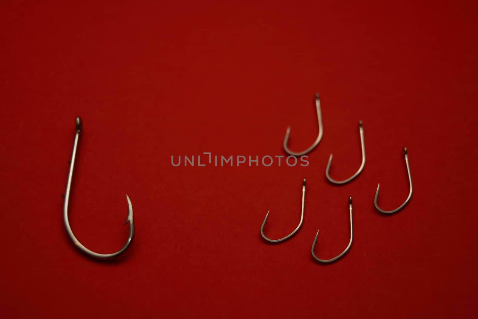 A set of fishing hooks in various conceptive situations.