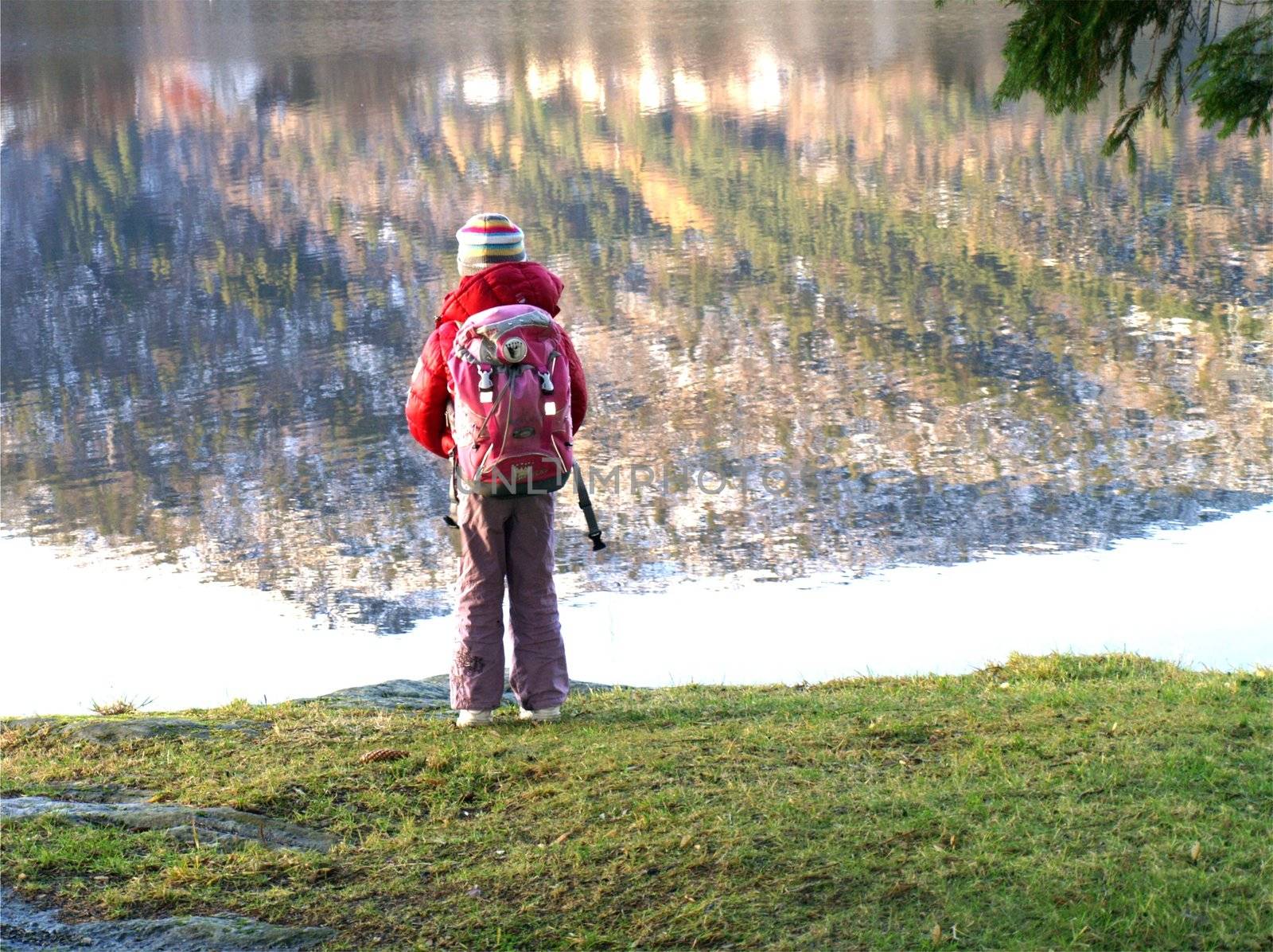 schoolkid standing by lake