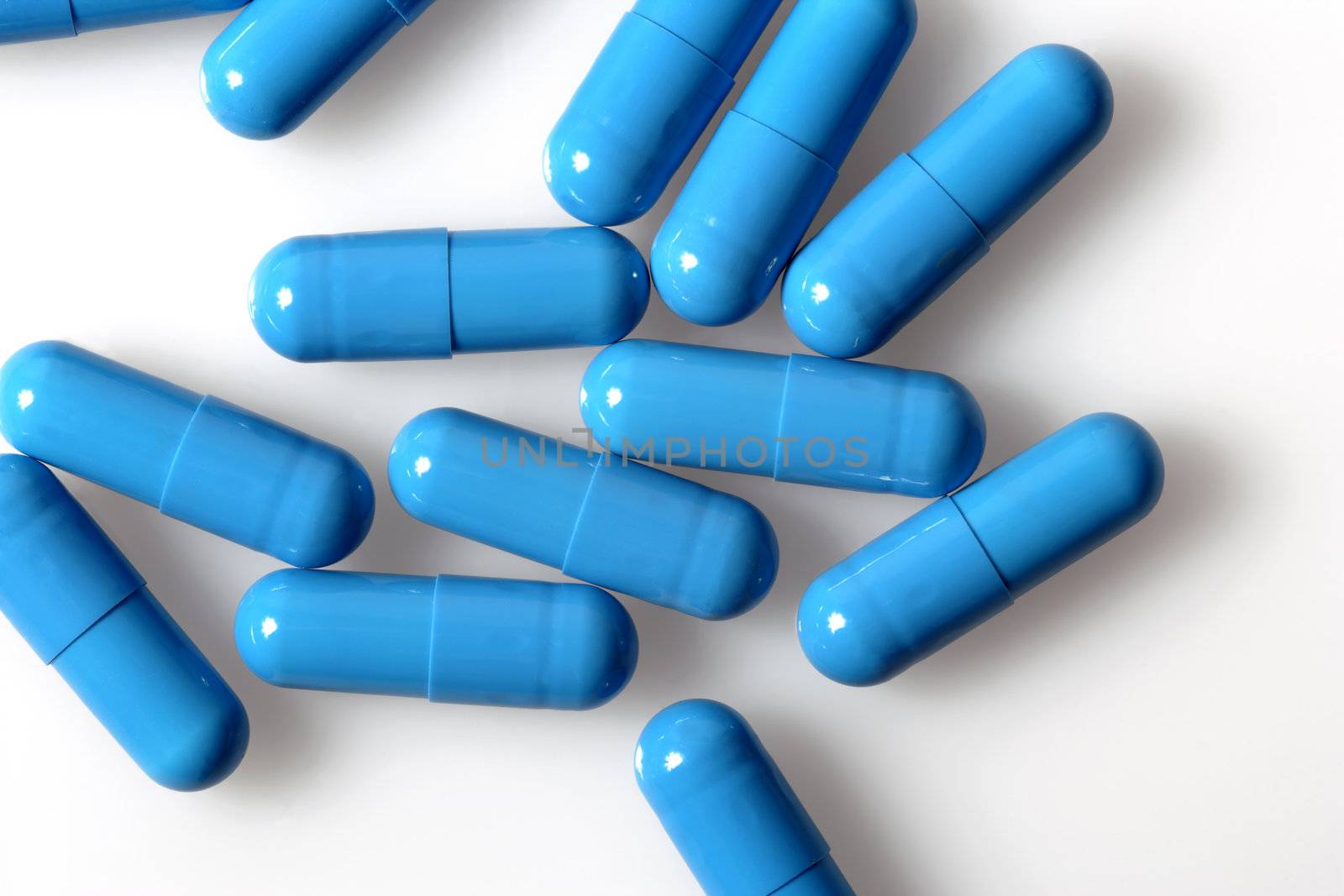 Blue capsules on a white background.

