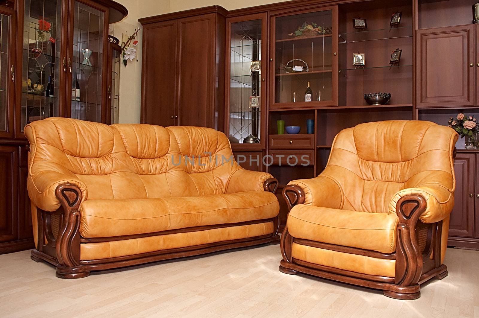 Yellow leather sofa and armchair on a parquet