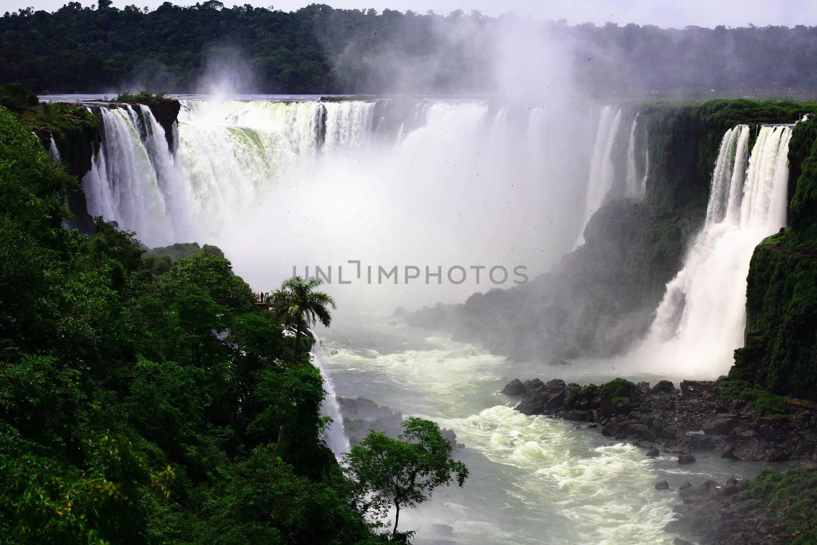 The Iguassu (or Iguazu) Falls is one of the largest masses of fresh water on the planet and divides, in South America, Brazil, Paraguay and Argentina. The waterfall system consists of 275 falls along 2.7 kilometres (1.67 miles) of the Iguazu River. Some of the individual falls are up to 82 metres (269 feet) in height, though the majority are about 64 metres (210 feet).