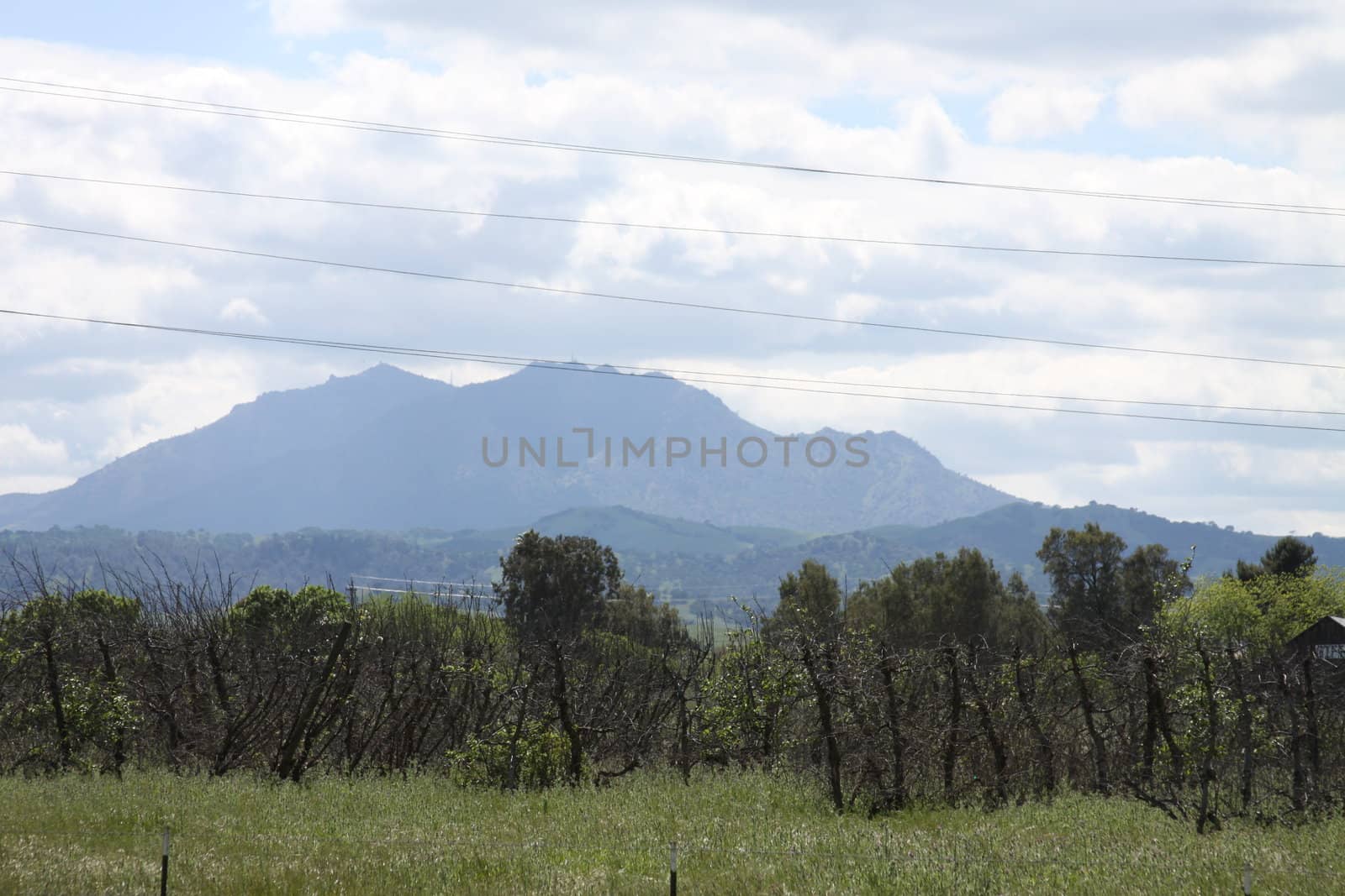 Tall mountain on a sunny day over blue sky.