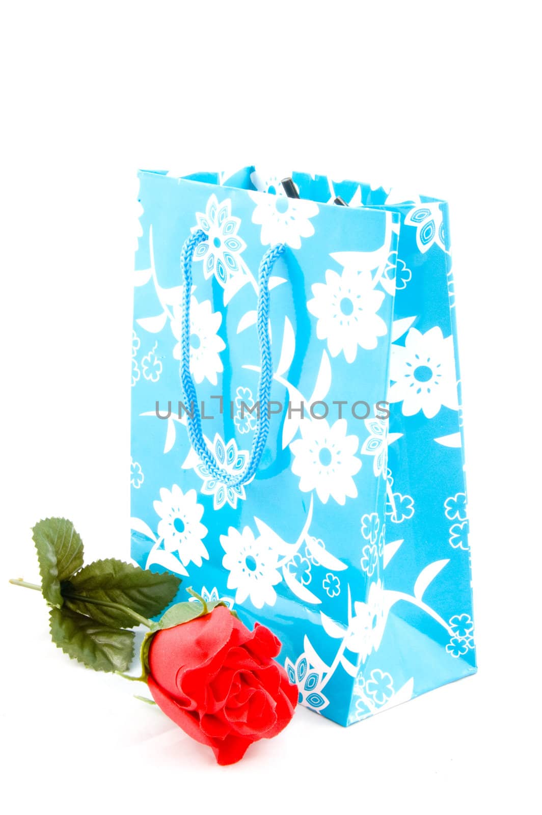 empty paper shopping bag with handles with red rose isolated  by ladyminnie