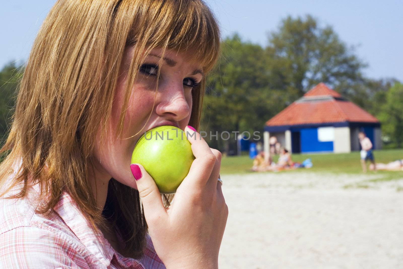 Teen girl eating apple. by SasPartout