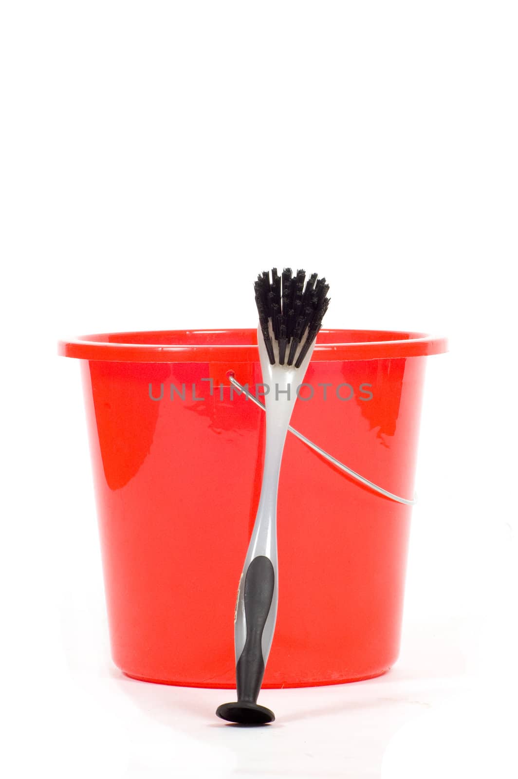 red bucket with gray dishwashing brush isolated on white