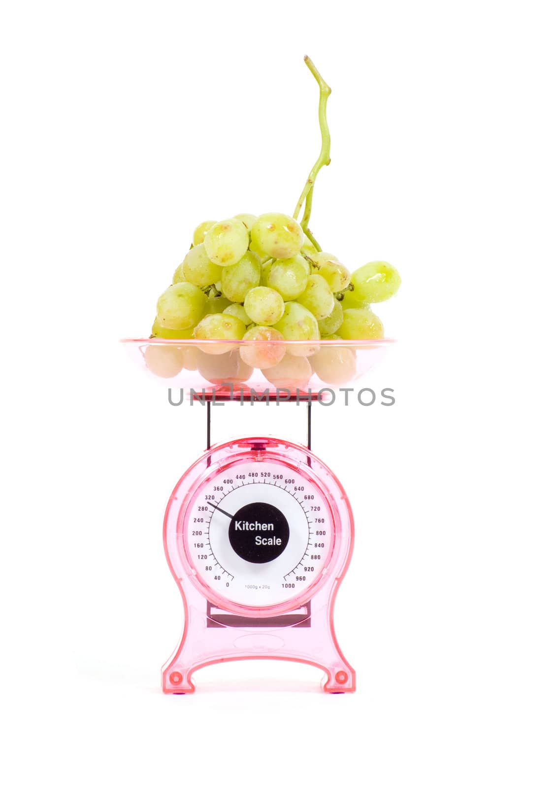 Kitchen Scales filled with green grapes isolated over white