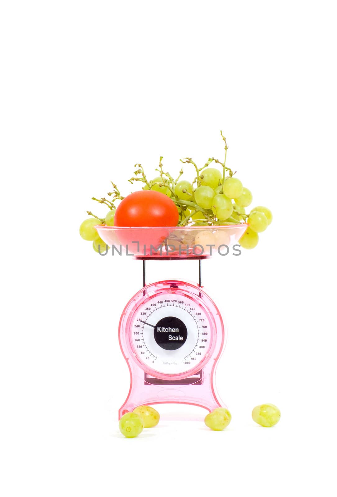 Kitchen Scales with fresh tomatoes and grapes  isolated over white