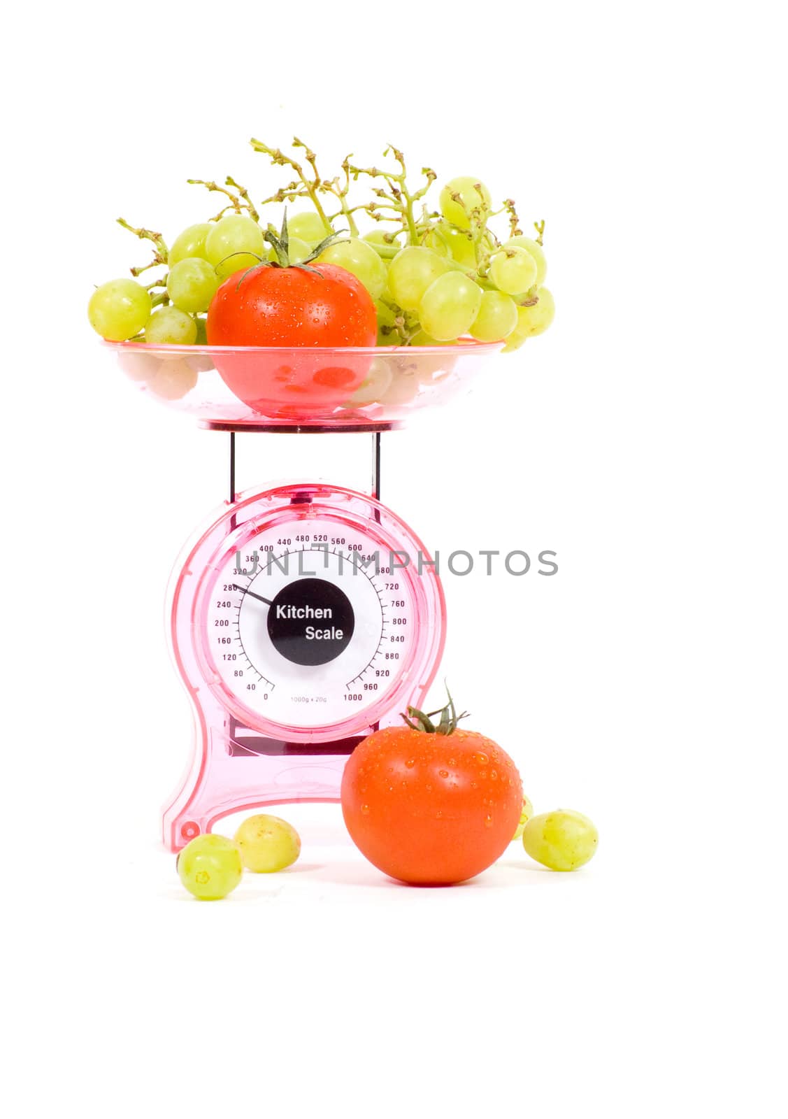 Kitchen Scales with tomatoes and grapes isolated over white