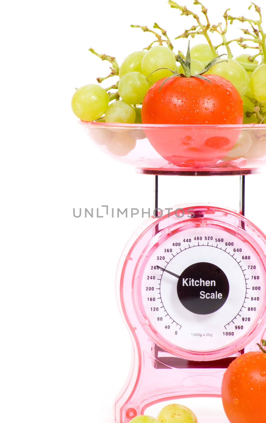 Kitchen Scales with fresh tomatoes and grapes  isolated over white