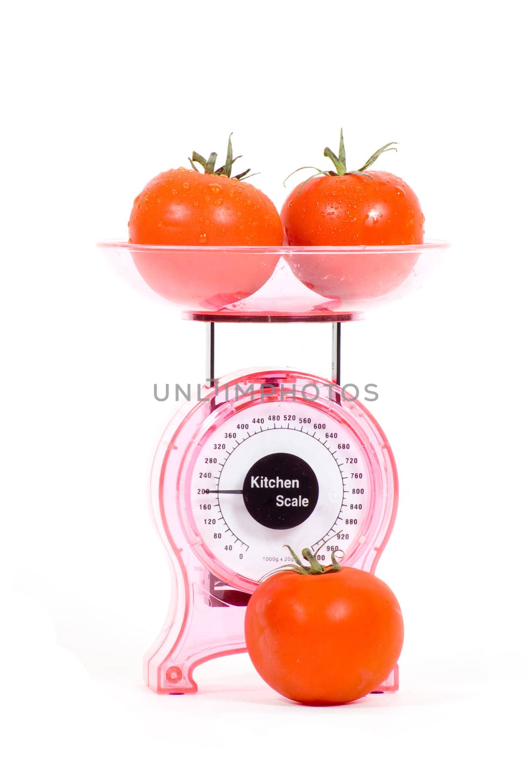 Kitchen Scales filled with tomatoes  isolated over white