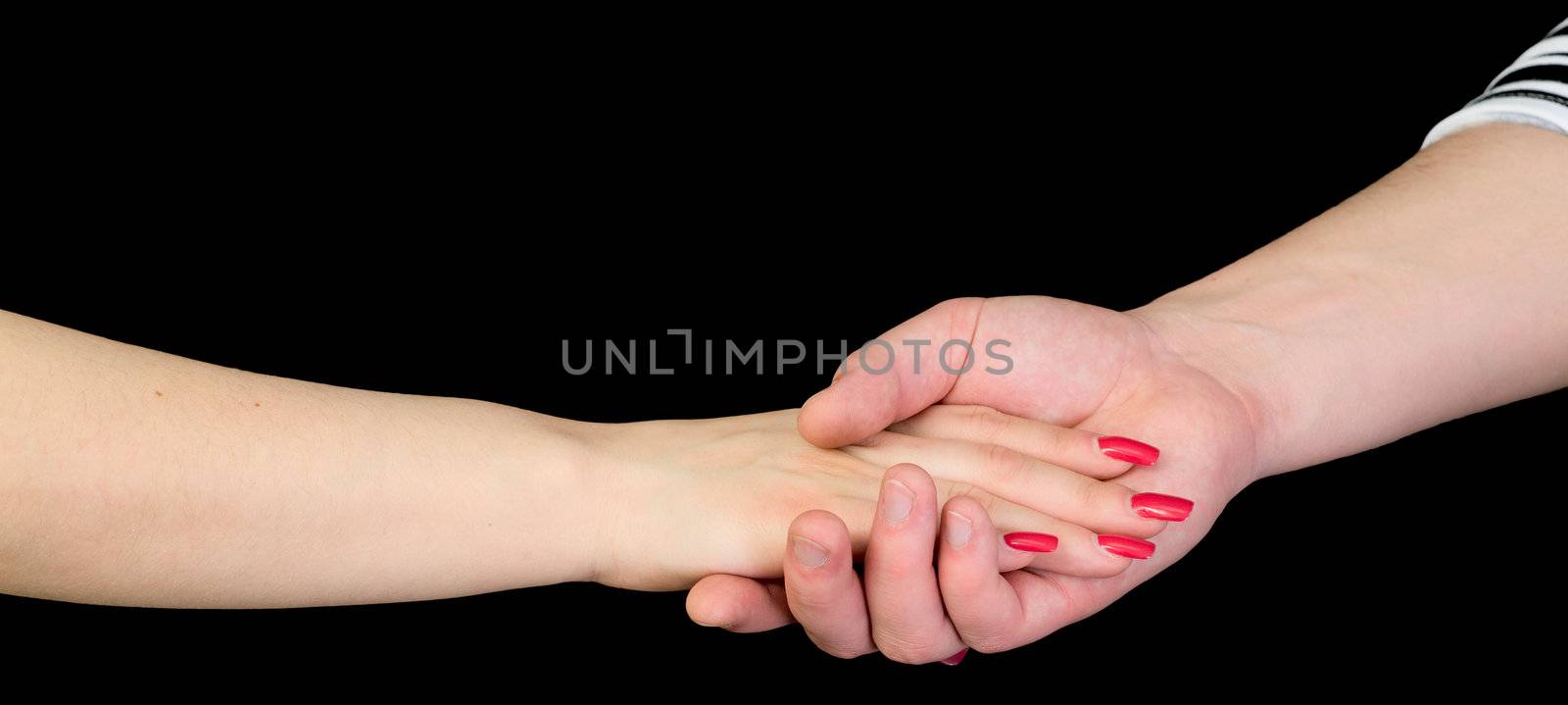 Female hand in a man's hand on a black background