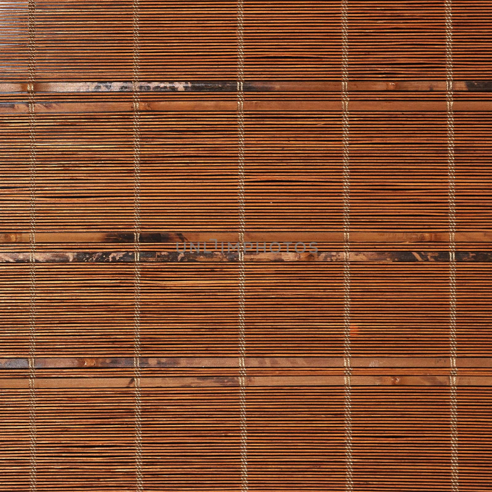 Bamboo tied together to form a mat with blades between each horizontal stick