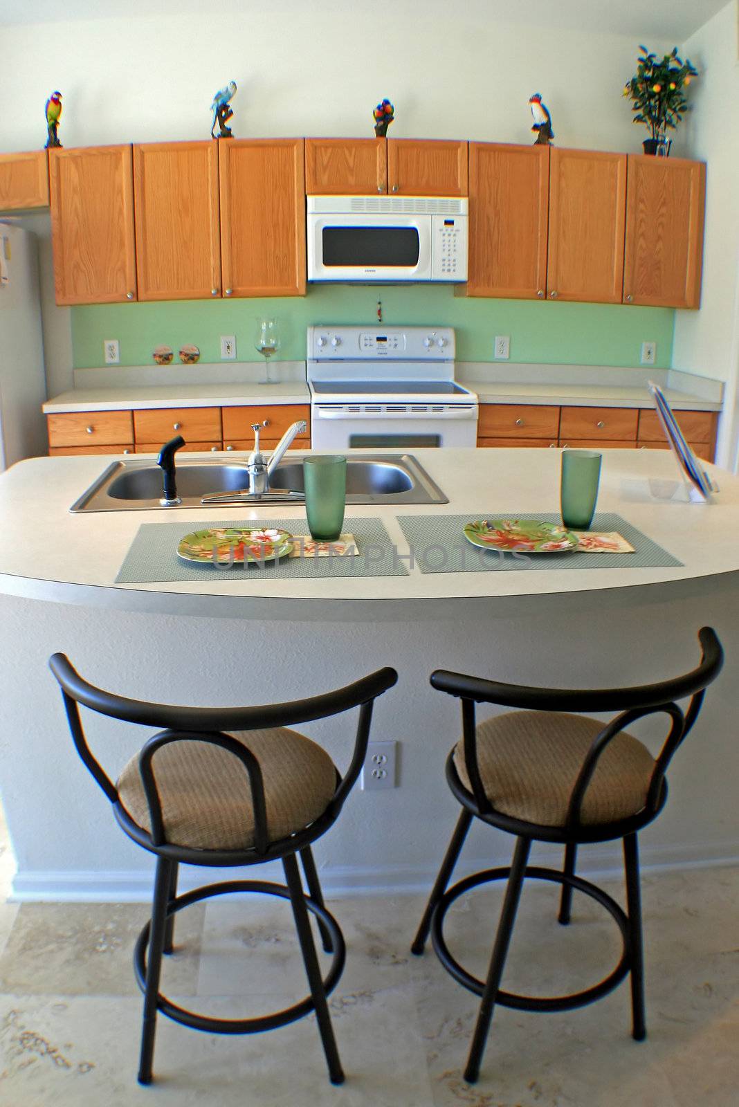 A modern kitchen in Florida with bar stools.