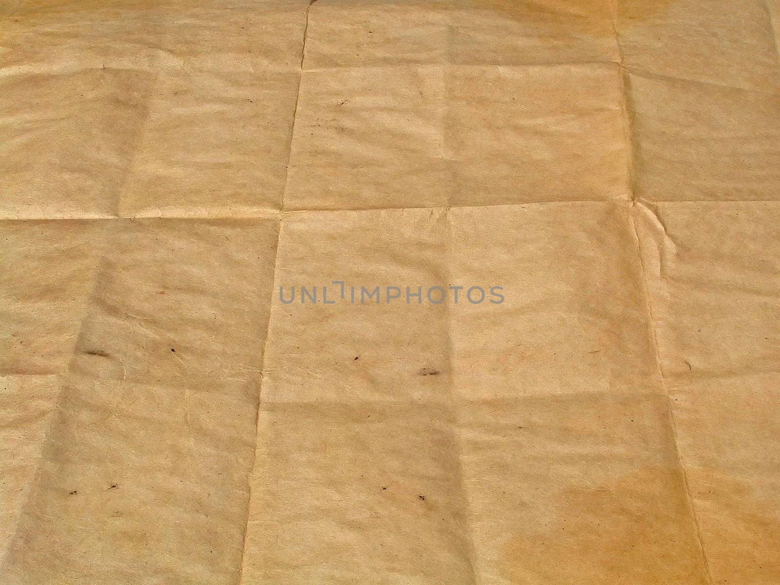Piece of old brown paper represented in the long term which has been combined by squares.