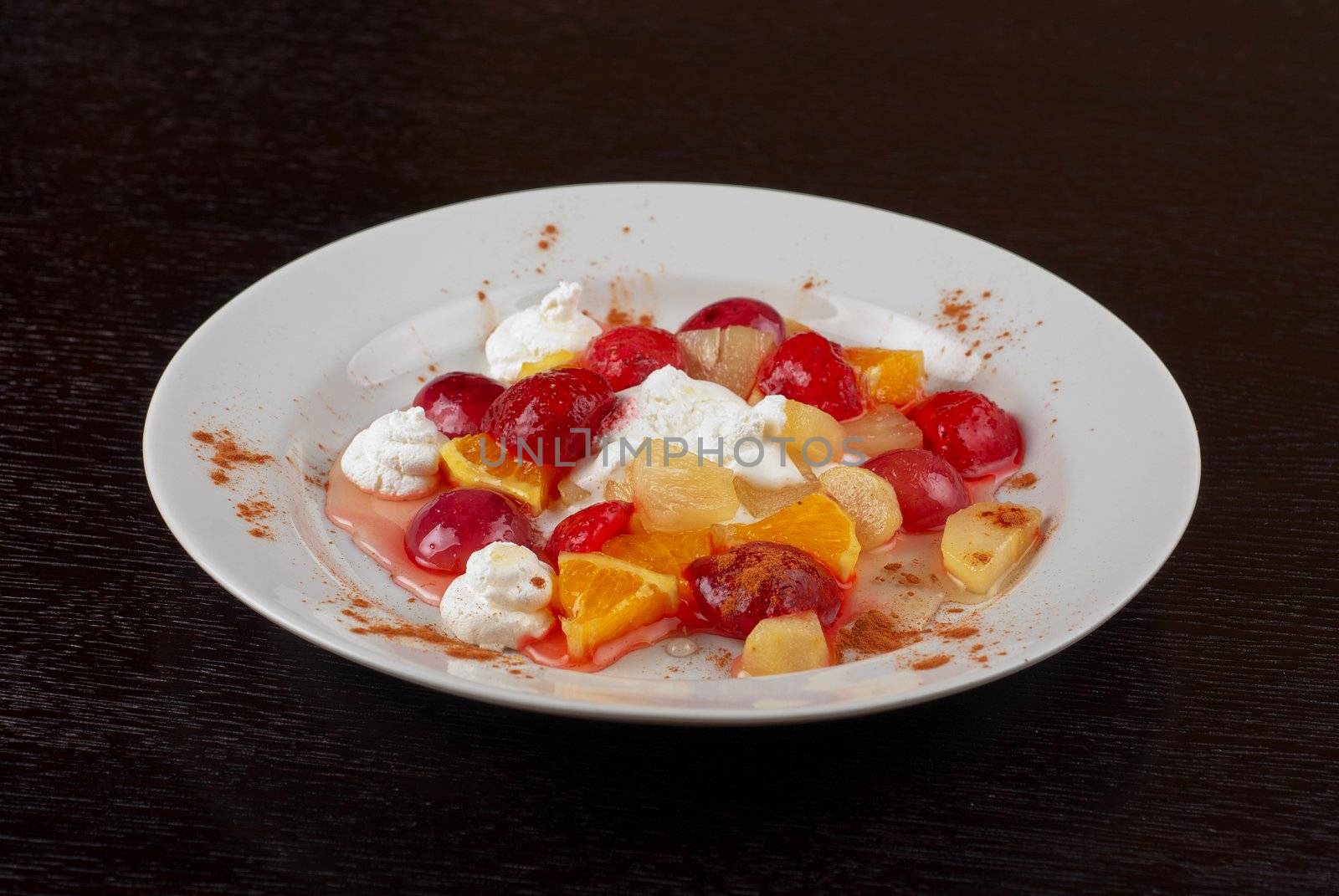 fruit salad of pineapple, grape, orange and strawberry with whipped cream