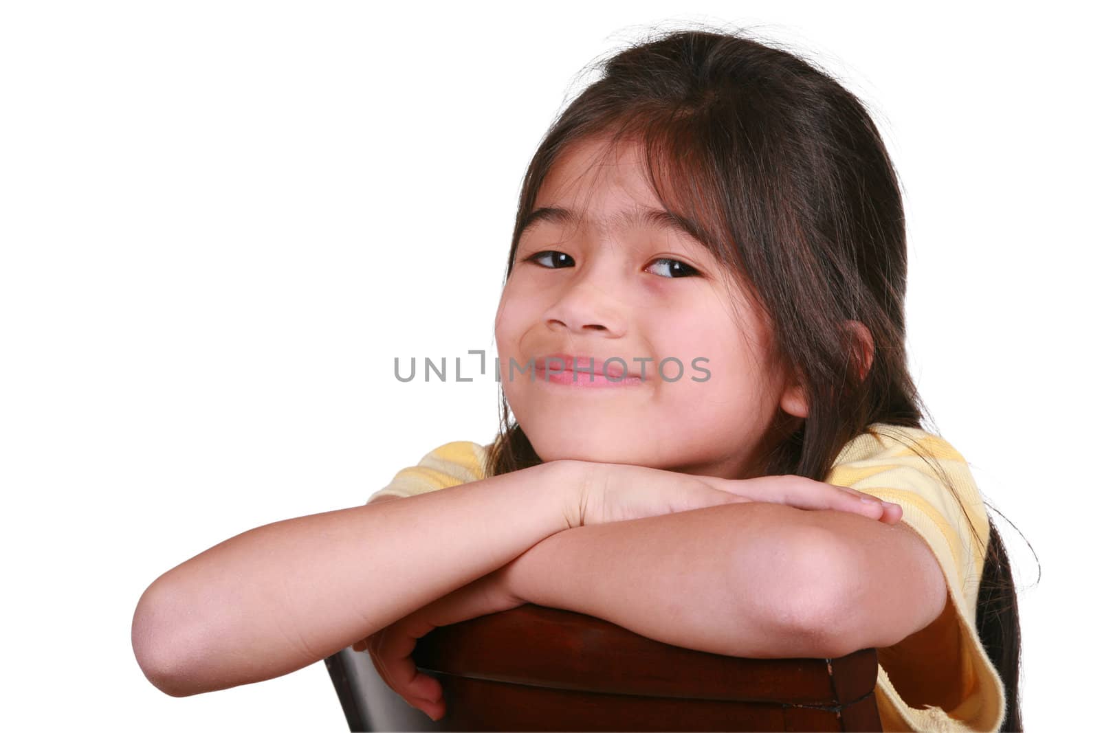 Beautiful little girl sitting on chair smiling, part Asian - Scandinavian descent