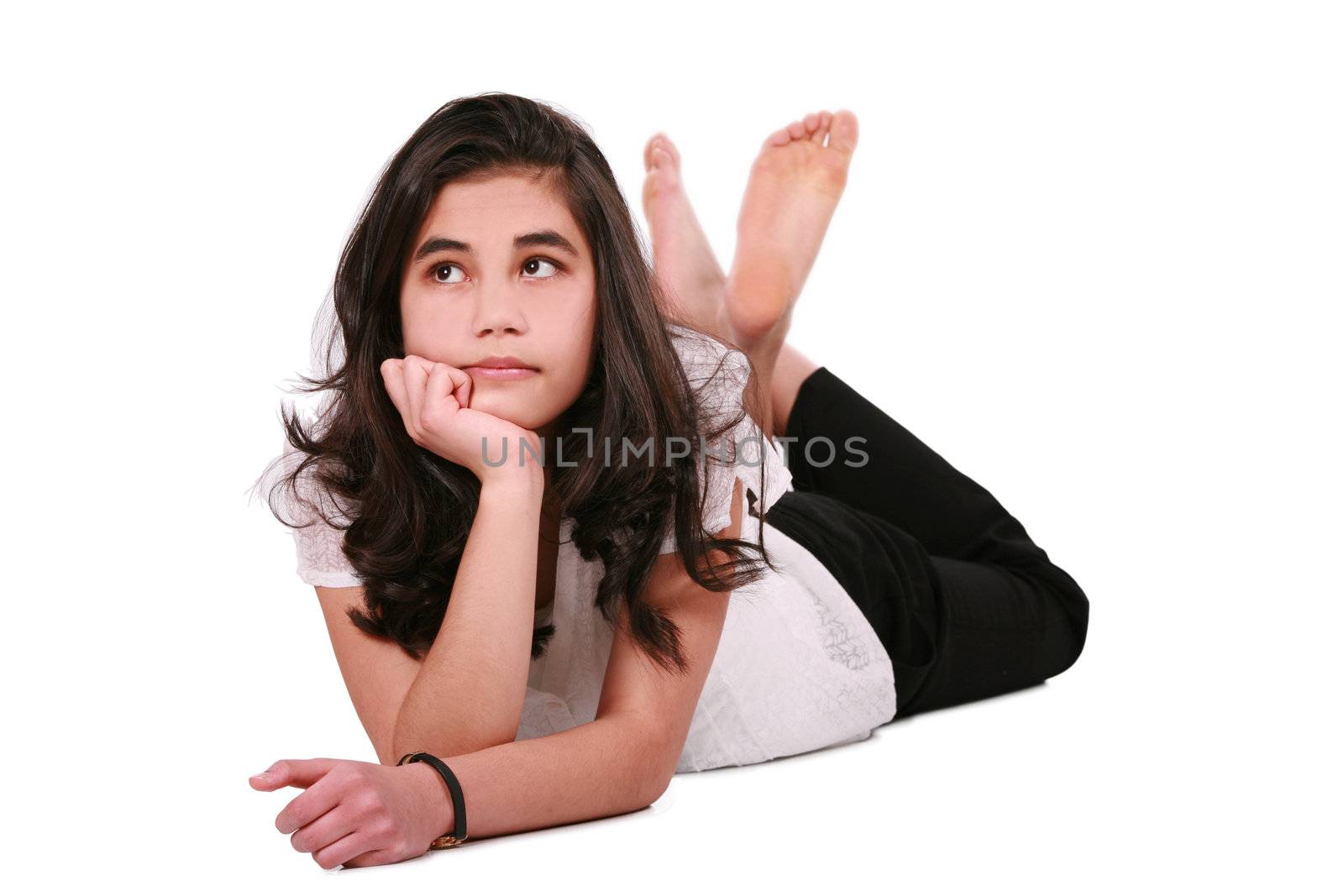 Beautiful teen girl lying on floor relaxing, part Asian- Caucasian background