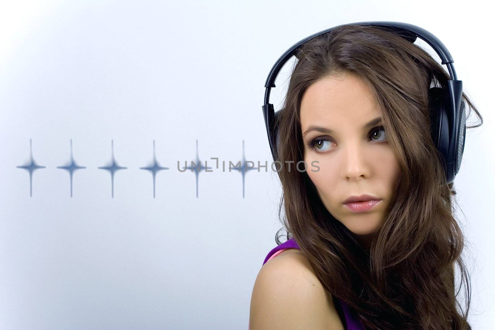 Young dj girl in club clothes with headphones on background with stars